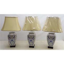  Three Oriental style ceramic blue and white table lamps on ebonised base with shades, as new, H36cm  