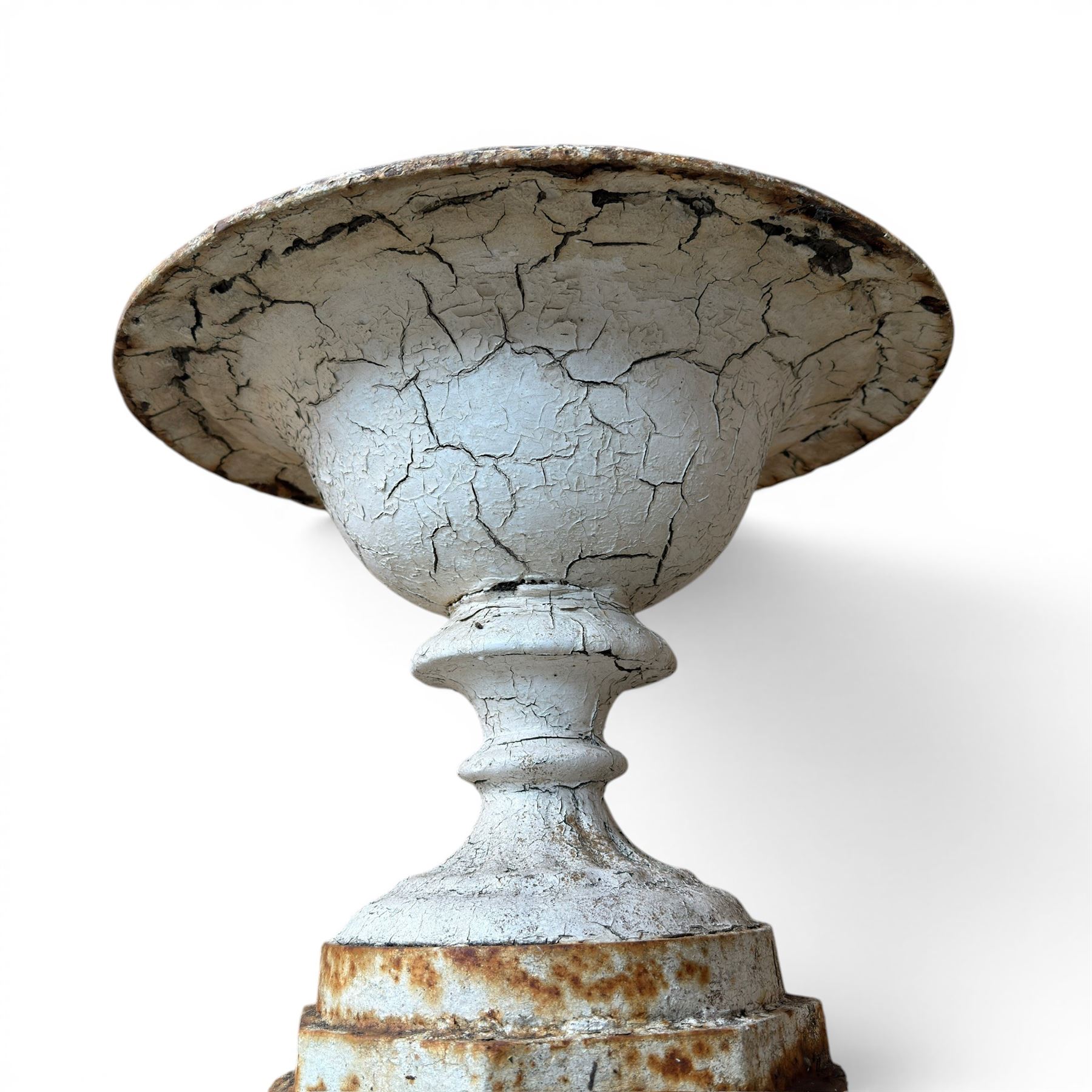 Victorian cast iron garden urn, egg and dart rim with shallow bowl, raised on stepped circular pedestal, finished in weathered white paint 