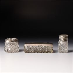 Silver upright photograph frame, aperture size 14cm x 9.5cm Birmingham 1919, pair of glass scent flasks with silver collars H16cm , two others, two dressing table jars with silver covers and a silver candlesticks