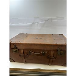 Early 20th century leather trunk, with brass fixtures, leather straps and buckle fastenings, embossed to the top with initials GG, H28cm, W76cm