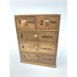 An Anchor Mills cotton reel chest, with two short over three long drawers, upon a plinth base, H29cm. 
