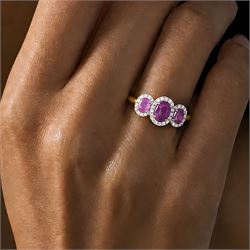 18ct gold pink sapphire and diamond trilogy ring, three oval cut sapphires surrounded by round brilliant cut diamonds, hallmarked, total sapphire weight approx 1.45 carat, total diamond weight approx 0.25 carat
