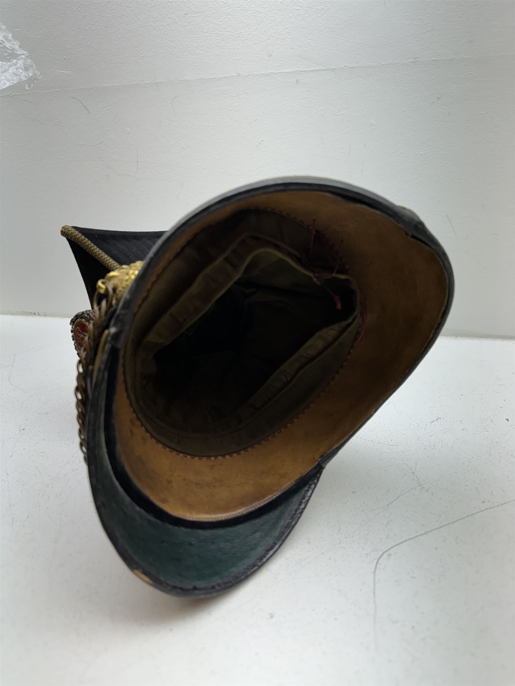 16th Queens Lancers Officers Lance Cap, black leather body with gilt braid lace and gilt wire braiding to the peak, officers silver gilt helmet plate to the front, the black cloth mortar board top with thick bullion wire, the bullion socket holder with embroidered GR cipher to the centre, lion head side bosses with velvet backed linked chinstrap, interior with leather sweatband and cloth lining, marked Carter & Co Pall Mall, the helmet is housed in japanned storage tin with brass plaque engraved “Lieu H L Evans, 16th Lancers'