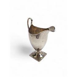1920s silver cream jug, of helmet form with loop handle and upon a square base, hallmarked Charles Edwards, London 1926, including handle H15cm