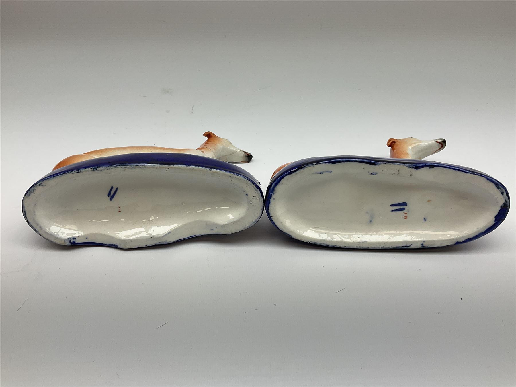 Pair of Staffordshire recumbent greyhound pen holders 