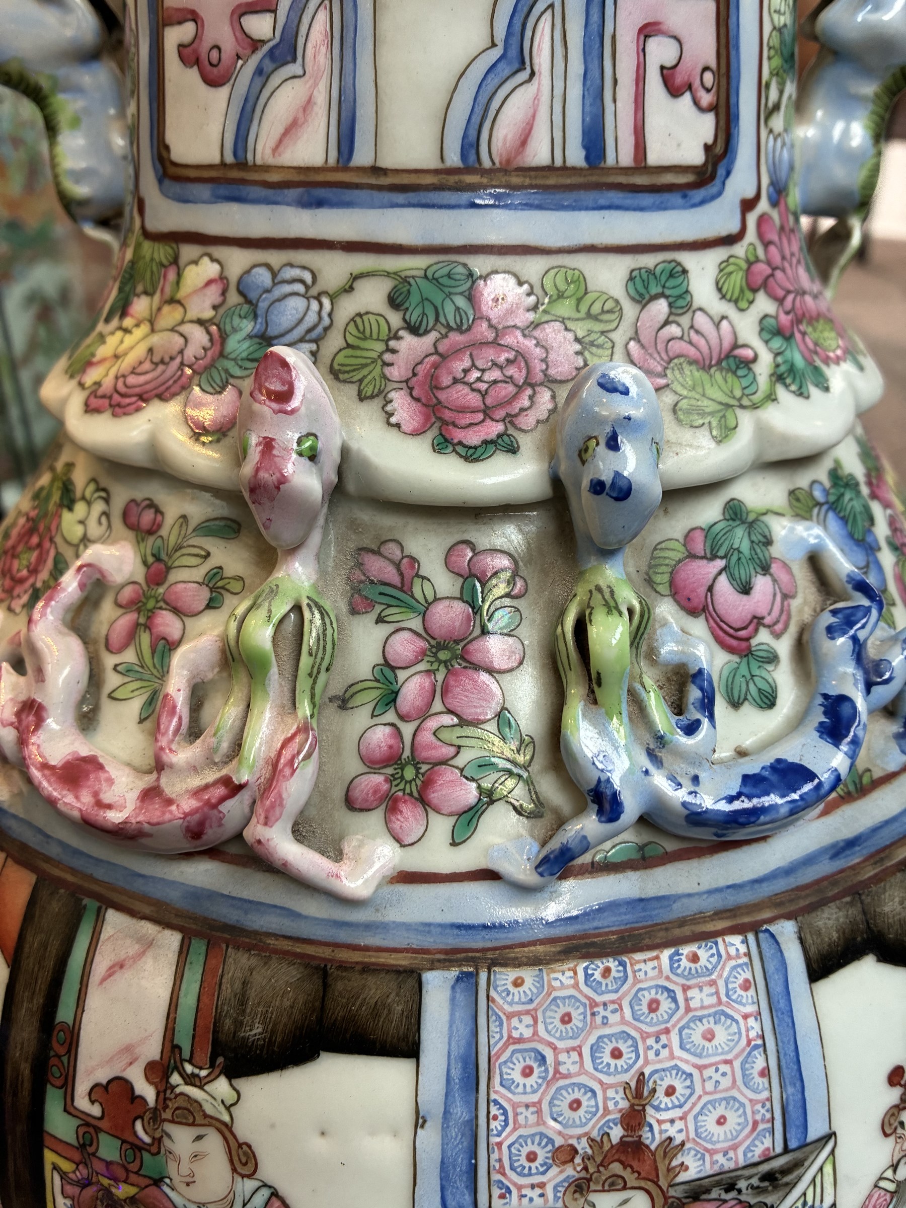 Large pair of 19th century Cantonese famille rose vases, each painted with various courtly scenes, including a display of warriors fighting on horseback before an official and his attendants, double Buddhist lion handles and applied at the shoulders with chilong, the lower band painted with Greek key motif, H58cm (2)