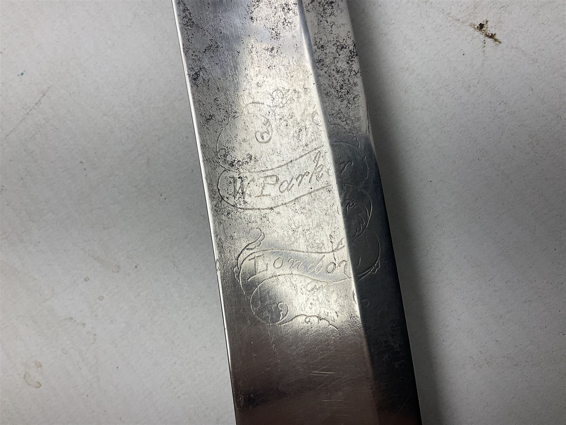 British pattern 1796 Light Cavalry Officer's sword, the 83.5cm curving steel blade marked 'W. Parker London' and 'Warranted' verso, brass stirrup hilt with half-round langets, knucklebow and backstrap with ribbed ivory grip; in brass mounted leather covered scabbard with two suspension rings L97cm overall. This item has been registered for sale under Section 10 of the APHA Ivory Act 