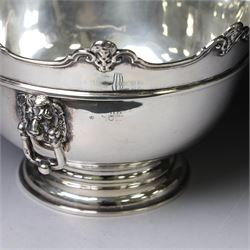 Edwardian silver Monteith punch bowl, the scalloped rim with strapwork and figural decoration, with two lion mask mounted ring handles, upon a circular stepped foot, hallmarked London 1903, maker's mark worn and indistinct, H15cm, D23cm