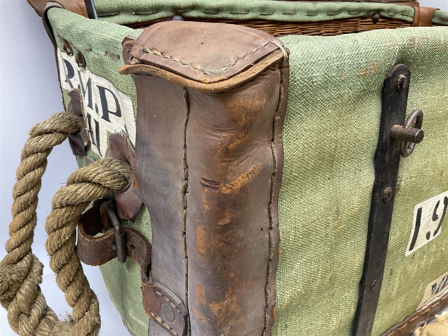 WW2 British Army RAMC 'Regimental Medical Pannier', well marked externally and dated 1941, stamped May 1943 internally, canvas covered wicker form with leather edges, hinged top and fall front with two rope carrying handles, fitted iron locking straps with securing chains; contains various unused field dressings and bandages with WW2 dates and two pillows; original label under lid L79cm