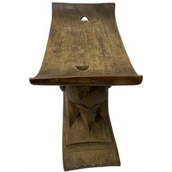 20th century African Ashanti hardwood stool, dished seat over a carved base in the form of an elephant (W52cm D30cm H50cm); with another similar, the dished seat over a circular support with carved and pierced central totem (W58cm D23cm H37cm)