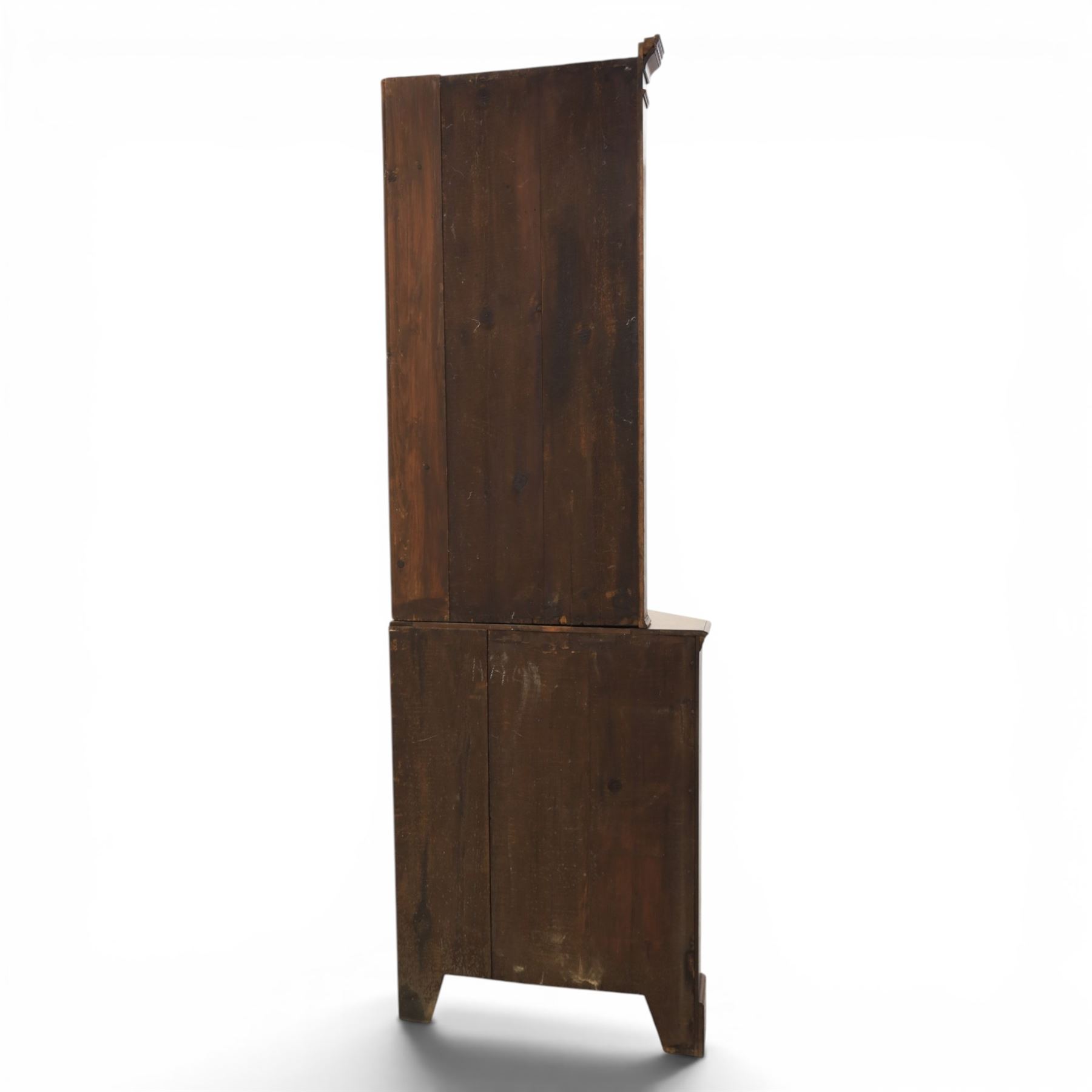 19th century oak floor-standing corner display cabinet, dentil cornice above astragal glass, shaped fixed shelves, the lower section with twin cupboard doors, on shaped bracket feet