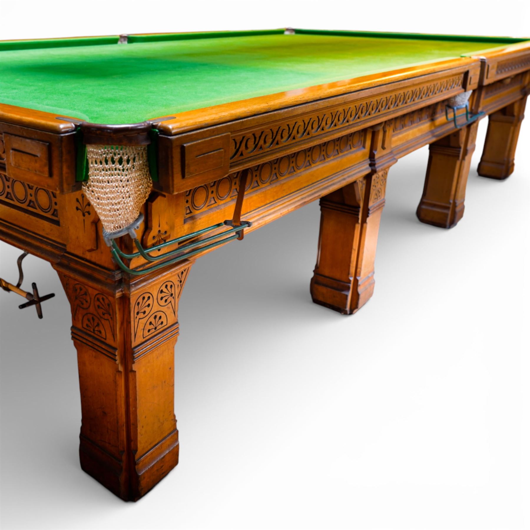 An outstanding bespoke late Victorian Aesthetic Movement golden oak full-sized snooker table of gothic influence, the rectangular slate bed covered in green baize within moulded rails and rounded pocket mounts, the protruding frame decorated with blind-fretwork frieze panels of Vitruvian scrolls and geometric ornament, over rails of repeating roundel carvings, raised on square chamfered and reeded supports with carved detail and panelled reserves, with further stylised brackets, stamped to the underside on all four edges R Anderson, serial number 4337
Viewing in situ near Tadcaster, please contact Chloe to arrange - 01904 393300