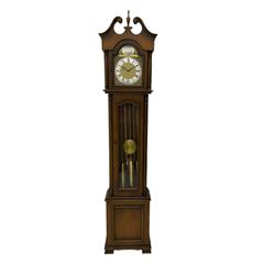 A 20th century “Grandmother” longcase clock in a light mahogany simulated case with a full-length glazed door displaying three brass cased weights and pendulum, brass dial with a slivered chapter ring and pierced steel hands, with an chain driven eight-day three train movement.


