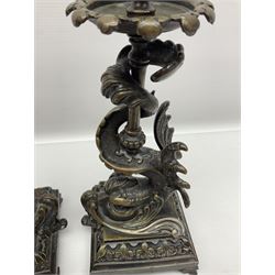 Pair of late 19th/ early 20th century brass candlesticks in the form of dolphins upon a stepped base with Fleur-de-lis design, H32cm 
