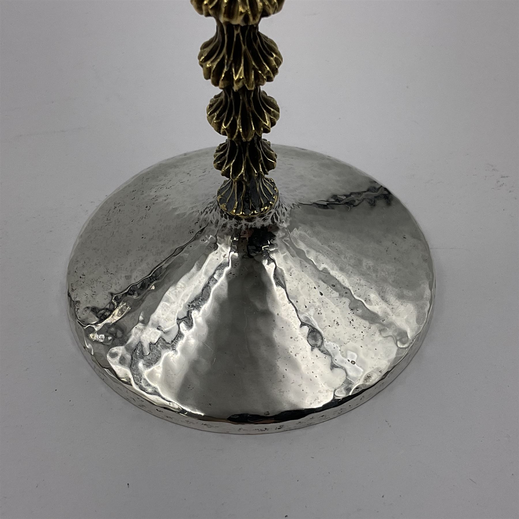 Pair of modern silver goblets by Stuart Devlin, the tapering cylindrical bowls each with spot hammered decoration and gilt interiors, the parcel gilt stems with signature textured detailing and six graduating knops, upon conforming spreading circular foot, hallmarked Stuart Devlin, London 1976, H17.7cm