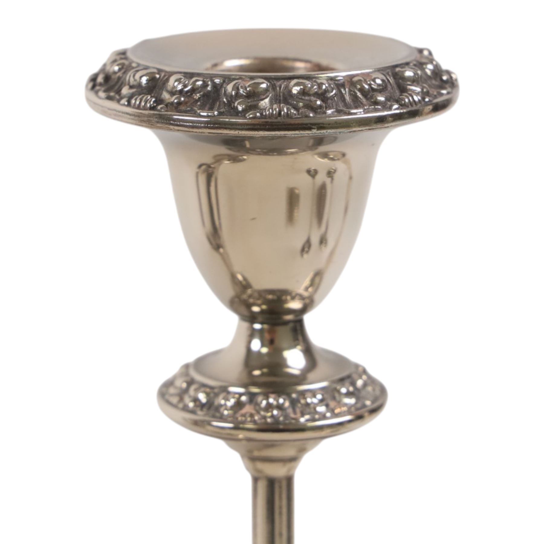 Silver plate two branch candelabra with grape vine decoration to the base, together with a matching pair of candle sticks and other candlesticks  