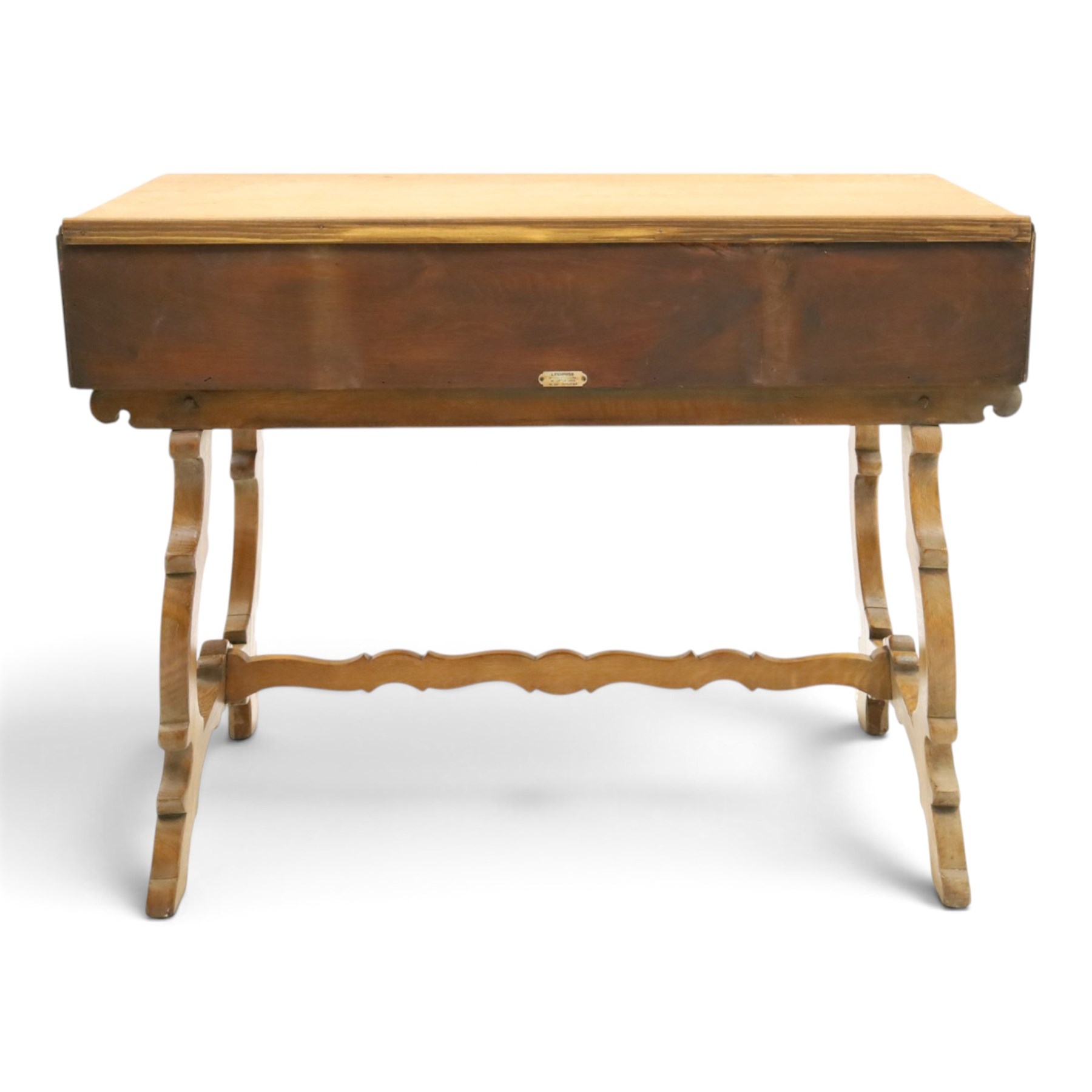 Leemings of Halifax (est. 1872) - Arts & Crafts oak side table, rectangular caddy top with raised moulded back, the frieze carved with central Yorkshire rose motif flanked by two drawers, raised on twin stylised lyre end supports formed of C-scrolls, united by shaped stretcher