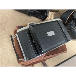 Kodak Dakon II folding camera and a collection of camera lenses and accessories, including Reflex-Nikkor  1:8 f=500mm, NikoN AF Nikkor 70-300mm 1:4-5.6G, Micro TM monocular lens and Teleshot adapter, two cases, Weston exposure meter, two cases etc