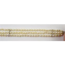 Three strand pearl necklace, with platinum diamond milgrain clasp and a single strand graduating pearl necklace with 18ct white gold clasp set with a diamond