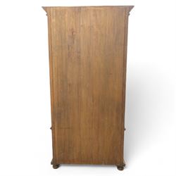 Pair of late 20th century Thai hardwood display cabinets, each with moulded cornice over twin glazed doors enclosing adjustable shelves, panelled cupboard doors below flanked by fluted columns, raised on bun feet