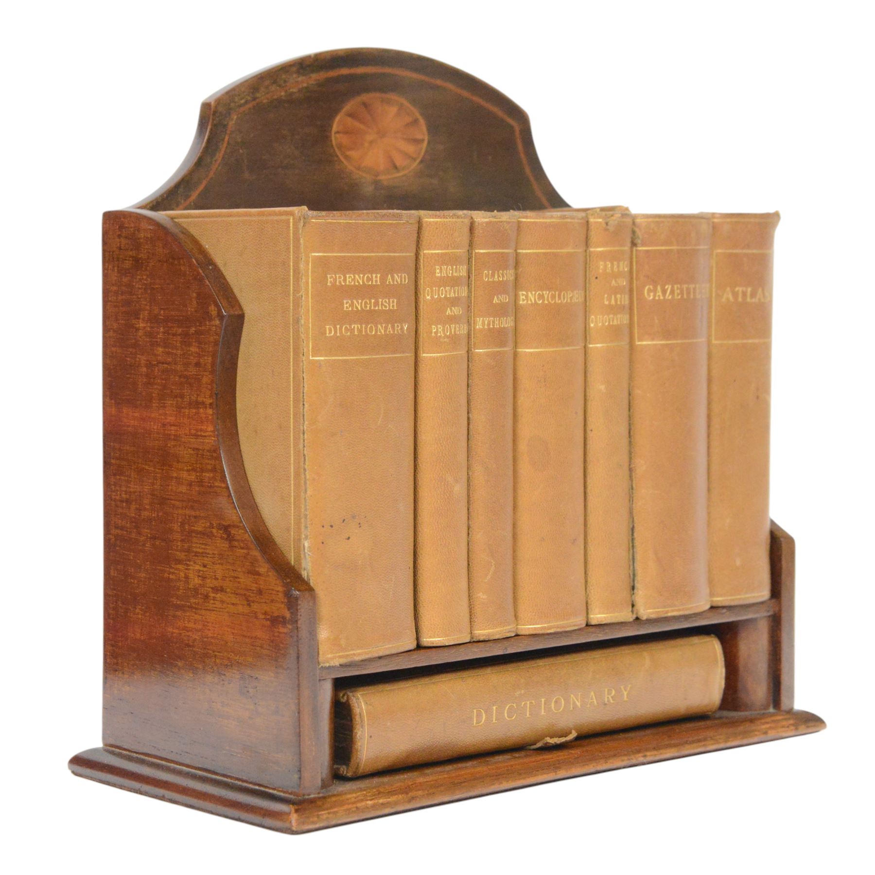 Edwardian Asprey mahogany desktop book trough, the segmental arched back with inlaid fan patera and serpentine shaped sides, above single recess and moulded base rail, housing Asprey & Co Ltd leather bound reference library, comprising Dictionary, French and English Dictionary, English Quotations and Proverbs, Classics and Mythology, Encyclopedia, French and Latin Quotations, Gazetteer, and Atlas, book trough, 22cm x 22.5cm x 11cm
