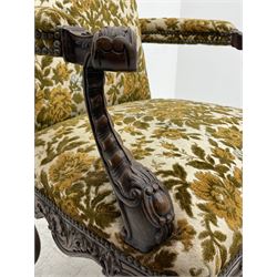 Late 19th century walnut open armchair, upholstered in floral patterned fabric, acanthus scroll carved arm terminals with scallop and cartouche carved supports, wide serpentine seat, shell and scrolled foliate carved apron, on scrolled cabriole supports