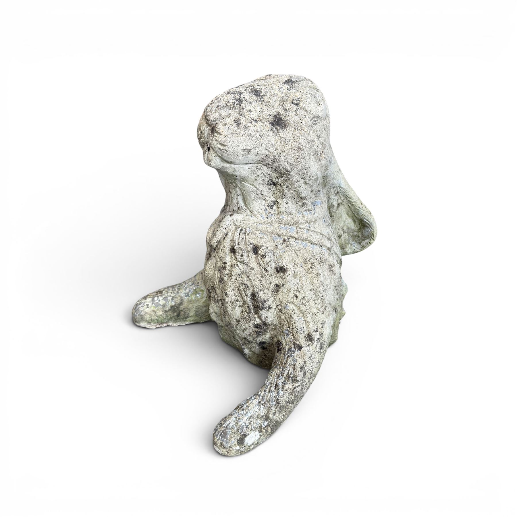 Two weathered cast stone garden hares