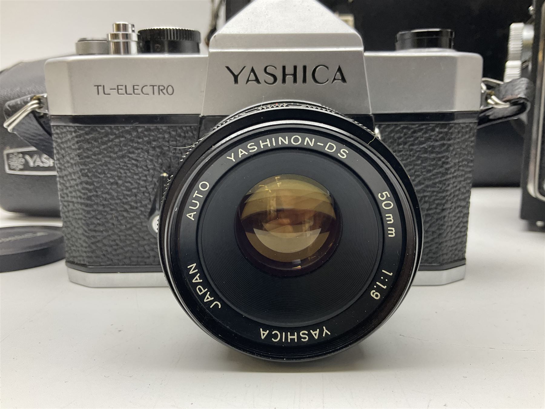Yashica-A camera body, serial no. A4080073, with 'Yashikor 1:3.5 f=80mm' lens, serial no. 209272 and 'Yashikor 1:3.5f=80mm' lens, serial no 22942, together with Yashica TL-Electro camera body, serial no. 5054162 with 'Yashinon-DS 50mm 1:1.9  40056038