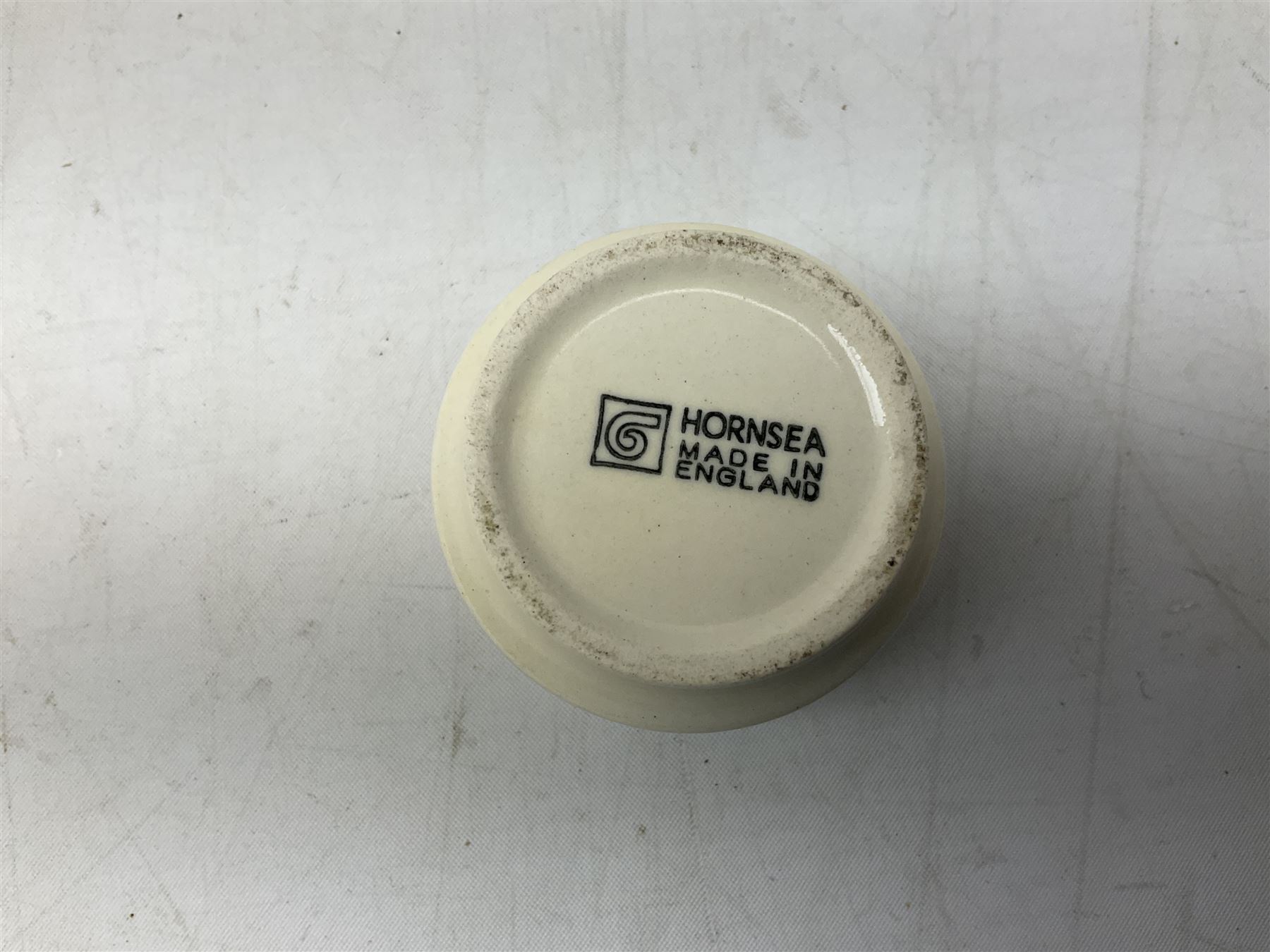 Collection of 1970s Hornsea mugs designed by John Clappison, comprising six Train Robber pattern examples together with owl patterned example on dark teal ground, and further example decorated with stylised hen and chick and egg, approx 9cm, together with four small cup bowls, all with stamped Hornsea marks beneath