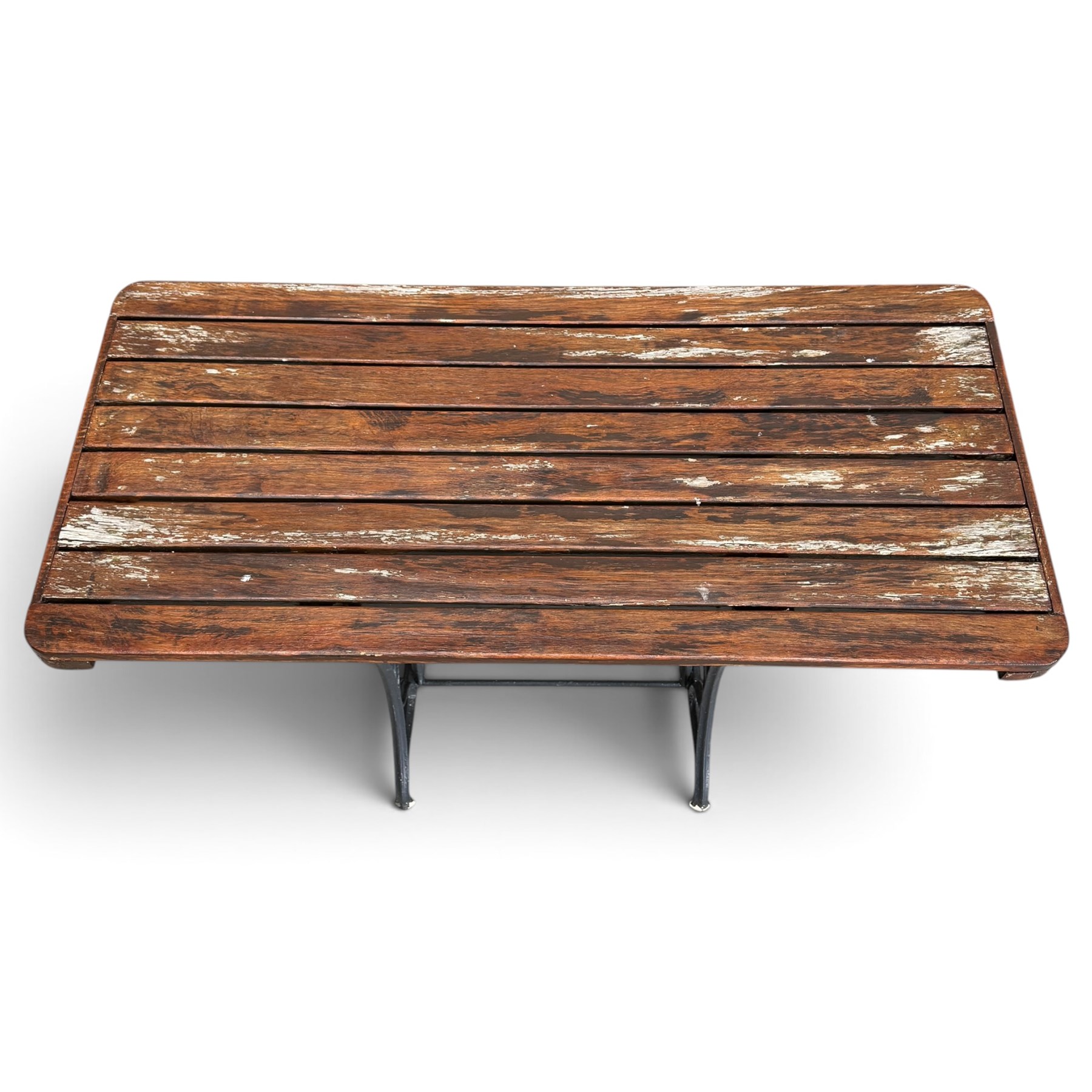 Antique rectangular slatted hardwood garden table, raised on pierced black painted cast iron supports cast with scrolling branchwork and united by pierced curved X-stretcher