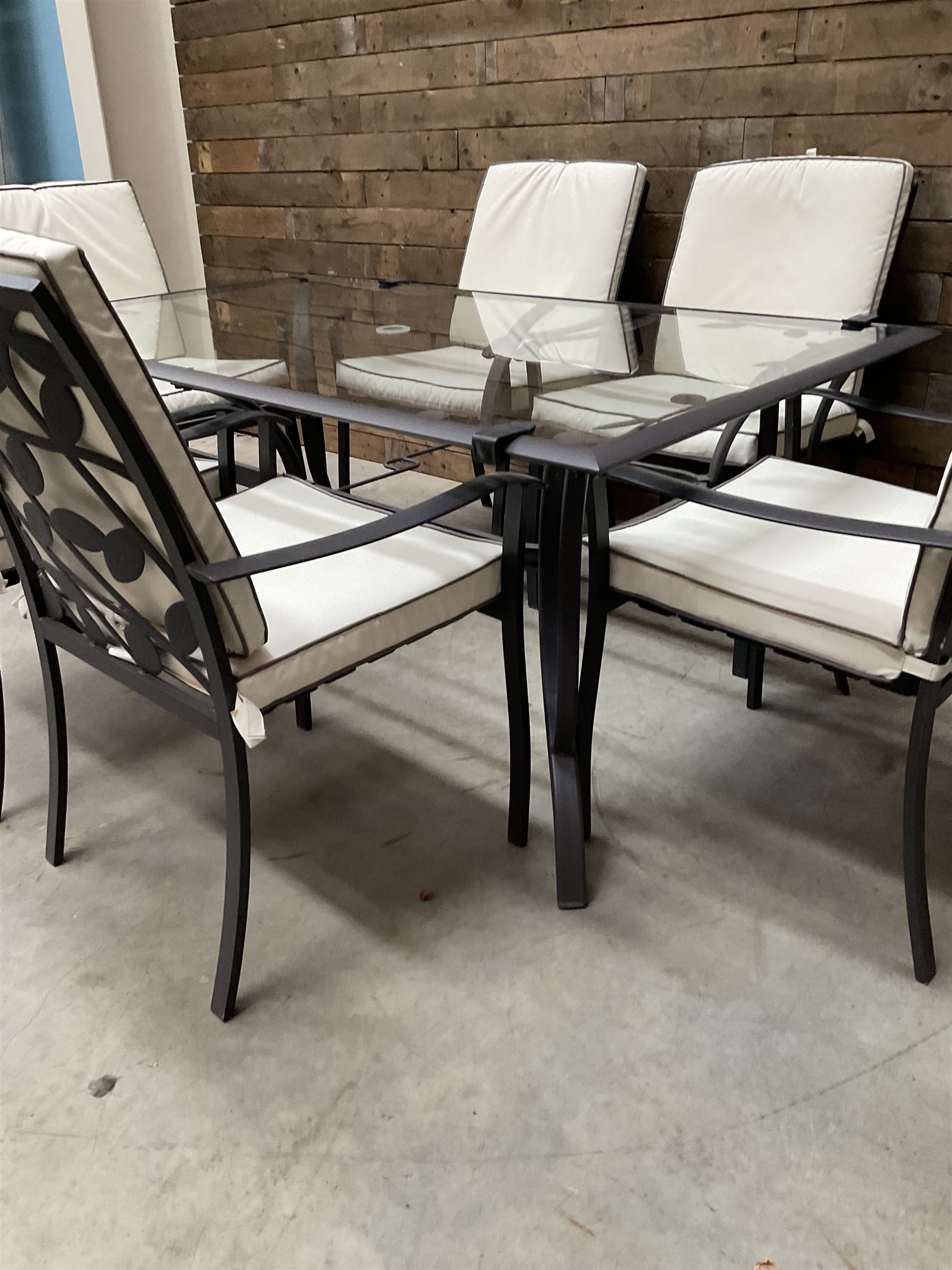 Metal framed garden table with glazed top (W170cm, D102cm, H71cm) and six armchairs with cushions 