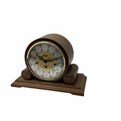 A 20th century  Westminster chime, spring driven three train “William Widdop” wall clock with a visible gridiron pendulum, chiming the hours and quarters on horizontal gong rods, white two-piece dial with roman numerals and minute track, steel spade hands, wooden case with full length glazed door and curved pediment with moulded cornice.
With key.
 
With a 20th century Westminster chime three train mantle clock with Hermle (German)  balance wheel movement chiming on four gong rods, ornate dial with Arabic numerals and minute track, contrasting black pierced steel hands, strike/silent lever.
H23cm W35cm D15cm