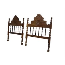 Pair Spanish stained beech single 3' bedsteads, spindle turned backs and carved with scrolling floral decoration 
