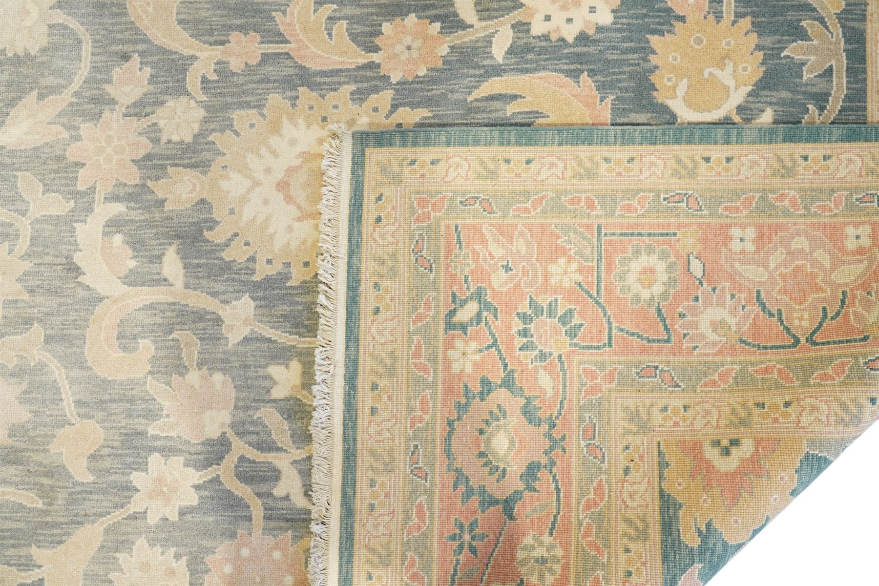 Indo-Persian indigo ground carpet, the field decorated with large palmette motifs connected by scrolling foliate, enclosed nu wide guard bands decorated with repeating interlaced stylised plant motifs
