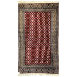 Pakistani Kashan hand-knotted rug with a central medallion and intricate geometric floral patterns, set against a red field and framed by a multi-band border (156 x 94cm); Pakistani Kashan rug with a repeating floral motif across the red field, enclosed by a detailed geometric border in complementary tones (162 x 95cm)