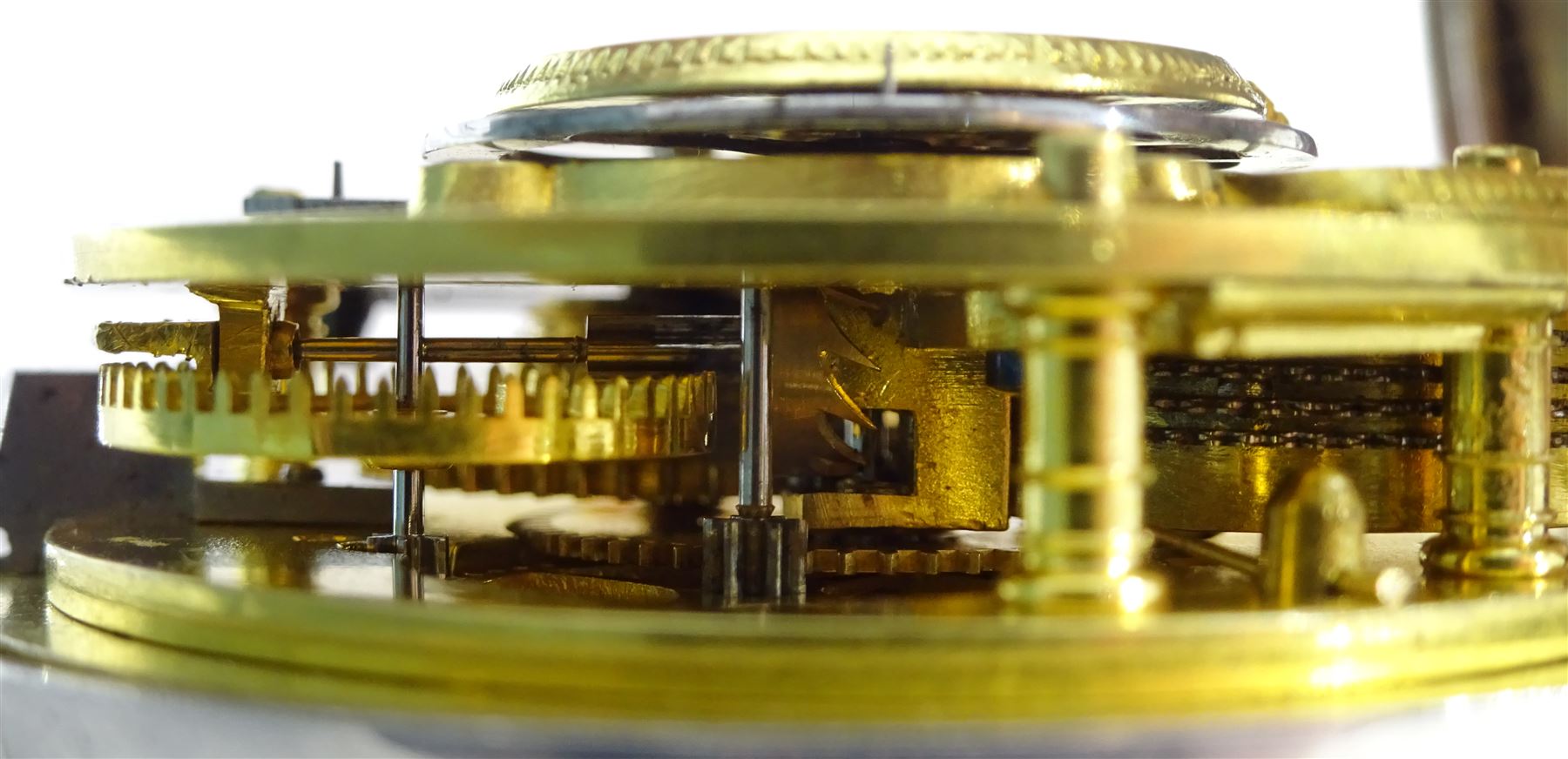 Victorian silver pair cased verge fusee pocket watch by J W Adcock, East Dereham, No. 98132, round pillars,  pierced and engraved balance cock decorated with a mask, enamel polychrome dial depicting a ploughing scene, Roman and Arabic numerals, case by Henry William Griffin, London 1864