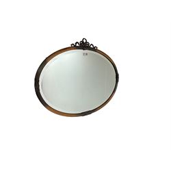 Early 20th century oval wall mirror with ribbon pediment
