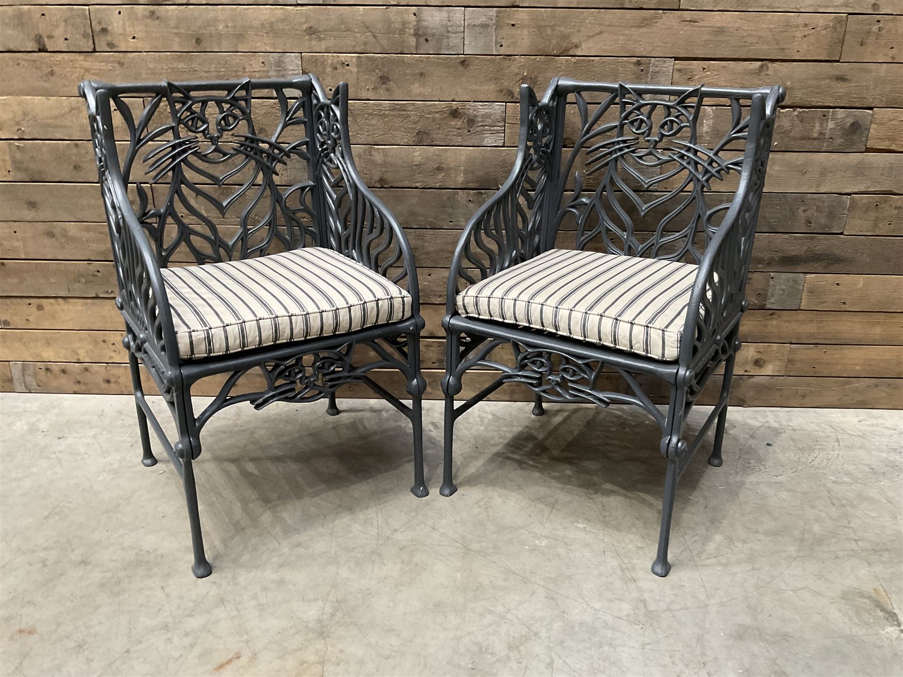 Richard Bawden (1936-2024): Pair of Cat design painted cast iron garden armchairs