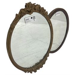 Late 19th century giltwood and gesso oval framed wall mirror, decorated with extending foliate decoration (46cm x 32cm); and a mahogany framed oval wall mirror with boxwood stringing (26cm x 37cm)