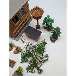 1:12 scale dolls house allotment and garden accessories, including wooden shed on a stone effect base, two vegetable patches, terracotta plant pots with flowers and foliage, stone effect plant pots, other planters, loose sunflowers, scarecrow, rabbit hutch, garden tools, fencing panels, etc 