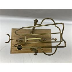 French brass wine pourer with mechanical action all on rectangular wooden base, together with a mahogany cased metal Sykes's Hydrometer