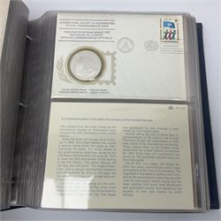 Thirty-one 'International Society of Postmasters Official Commemorative Issues' sterling silver proof medallic covers dating from 1975 to1977, housed in the official folder and a 'Commemorating The Bicentennial Of The United States Of America' sterling silver proof medallic first day cover in blue wallet
