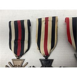 Two WW1 German medals - copy Cross of Honour with swords (combatants); Cross of Honour without swords (non-combatants); and two WW2 German medals - War Merit Medal; and War Merit Cross; all with ribbons (4)