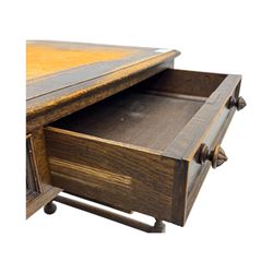 Early 20th century Jacobean design oak desk, with rectangular top inset with worn tooled leather, two frieze drawers over pedestals each fitted with a pair of panelled drawers, turned handles, on carved and fluted tapering legs united by stretchers 