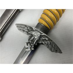WW2 German Luftwaffe 2nd Pattern Officers dress dagger, with unmarked 25.5cm double edged steel blade, wire-bound pale orange/yellow celluloid grip, globular  pommel with oak leaves and traces of gilding, Luftwaffe eagle cross guard; in beaded scabbard with two suspension rings L43cm overall