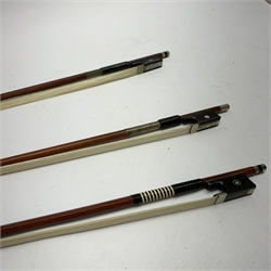 Three pernambuco bows by F.C. Pfretzschner with silver mounts, Adolf Thoma and Tourte