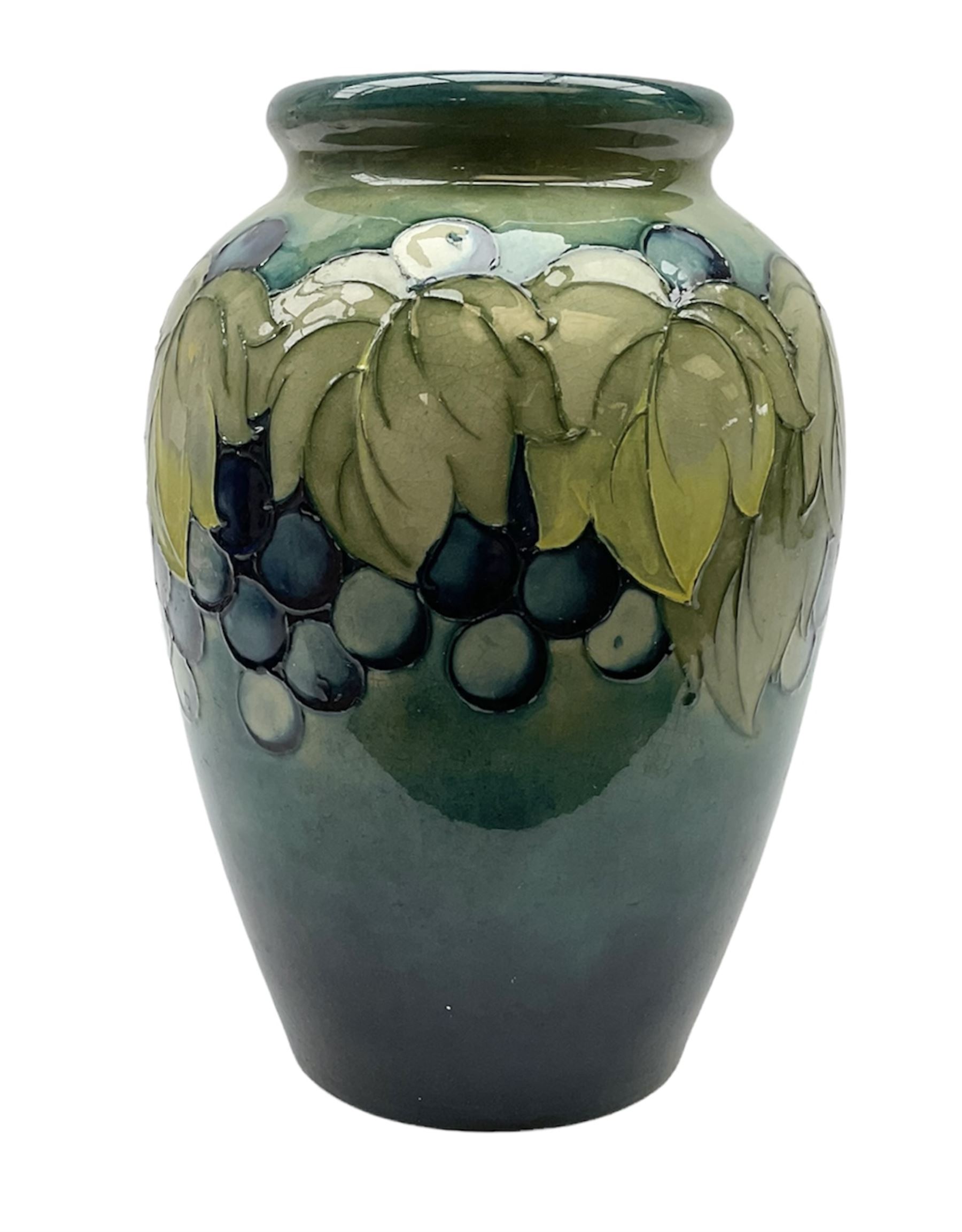 Moorcroft Grape and Leaf pattern baluster vase on green and blue ground, with impressed and painted mark beneath, H24cm
