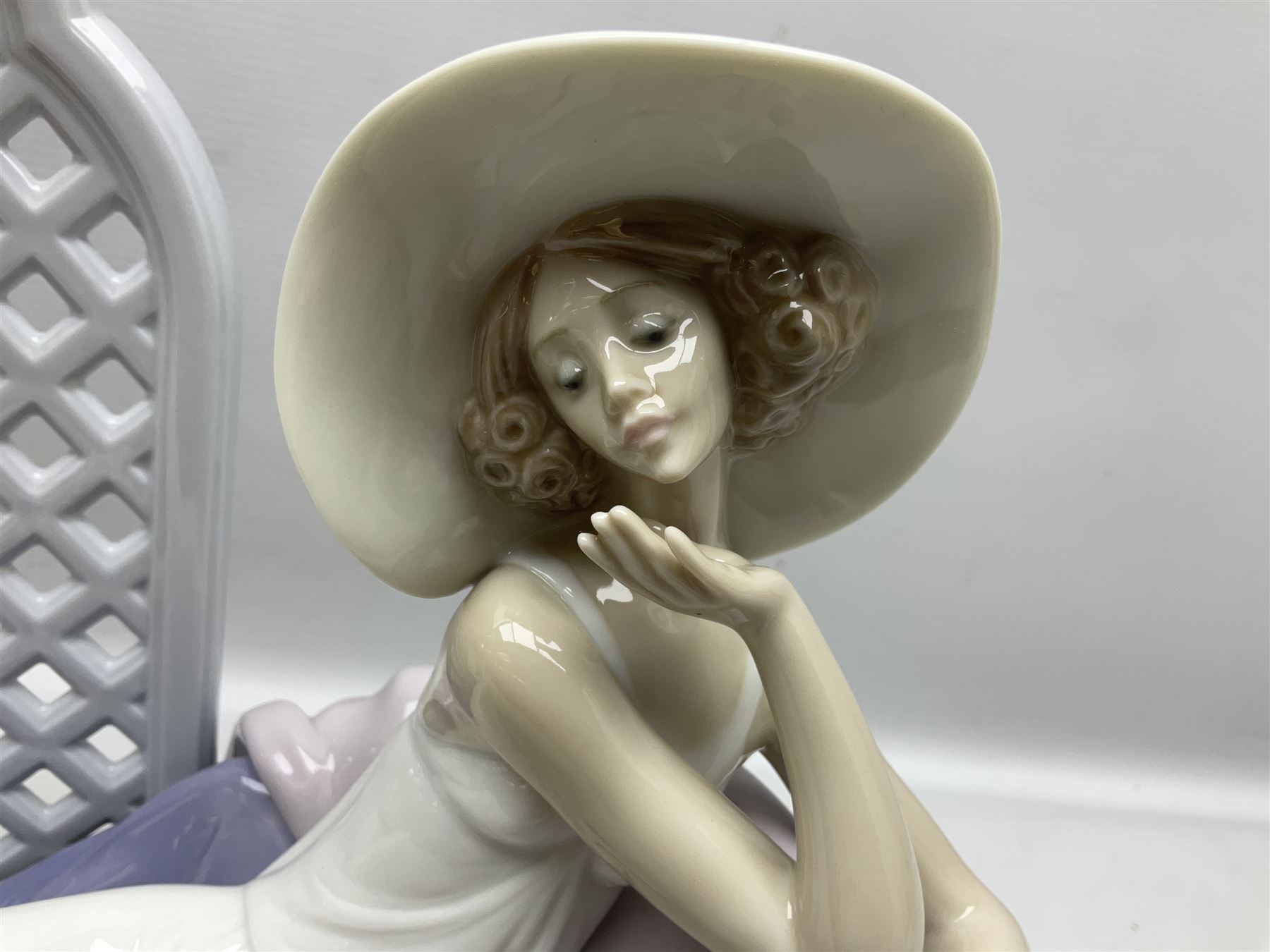 Lladro figure, Garden of Dreams, modelled as a woman reclining in front of trellis of flowers on a mahogany base, limited edition 3129/4000, sculpted by  José Puche, with original box, no 7634, year issued 1994, year retired 1996, H32cm