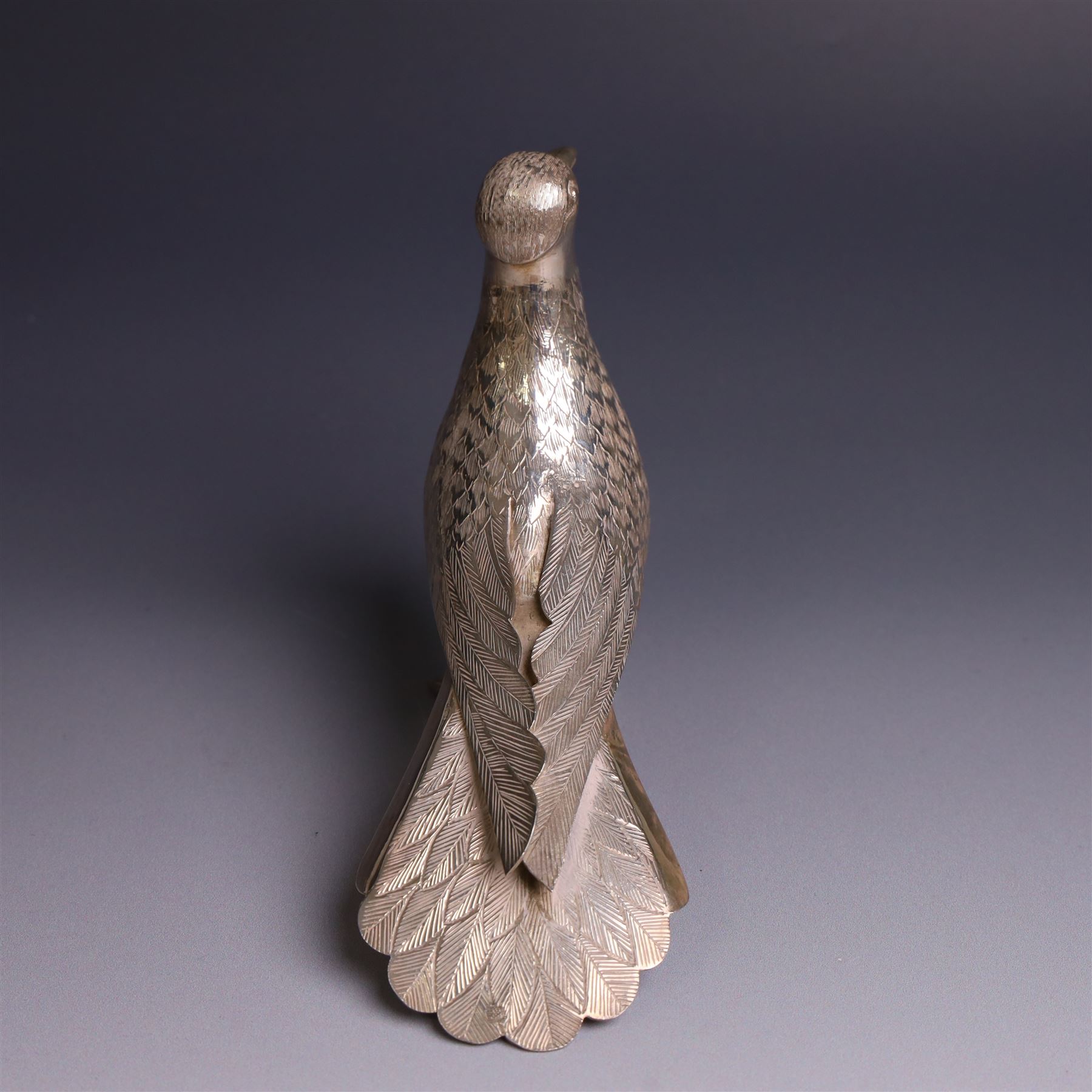 Mid 20th century Iranian silver model of bird, with engraved feathers, stamped with lion with scimitar to underside of tail, H11cm