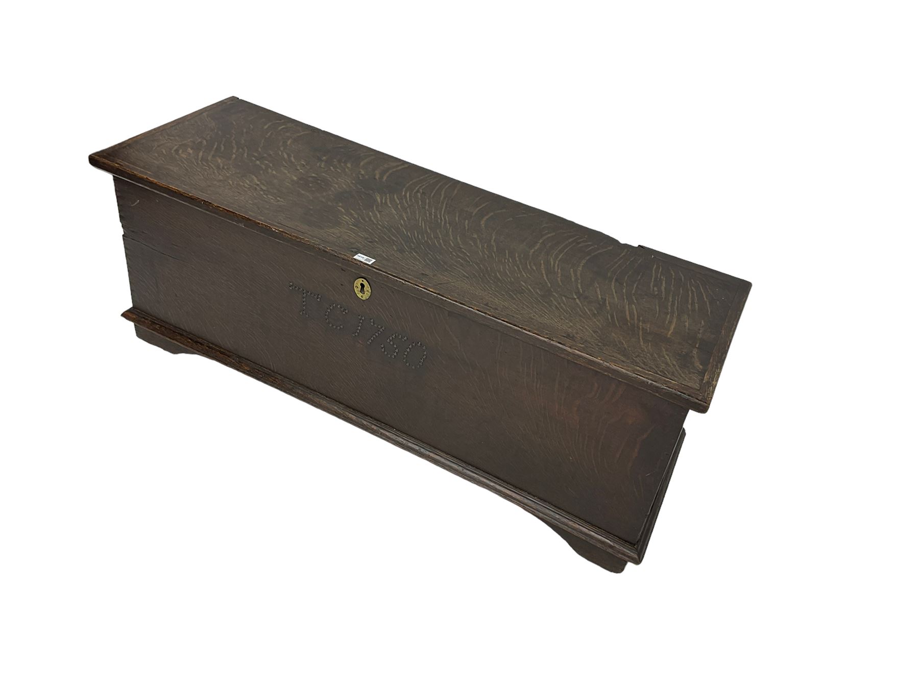 18th century oak sword chest or coffer, hinged lid with moulded edge and iron fittings concealing candle box and main compartment, the front with studwork spelling 'TC 1750', raised on bracket feet